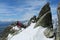 Climbers on the rock and snow alpinist route