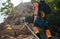 Climbers woman and man in protective helmets and climbing harnesses ascending cliffs on rock wall in Paklenica National park site