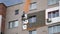 Climbers are working on the insulation of facades of a multi-storey residential building. Builder working at height while holding