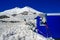 Climbing boots drying on sticks of climbers on the background of snowy peaks of Mount Elbrus. Gara Bashi Base Camp.