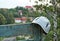 Climbing helmet on a back of a bench on viewpoint with buildings in the background