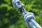 Climbing ropes with carabiner on blurred green background, closeup