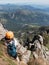 Climbing sport: caucasian young boy takes a rest observing the m