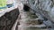 Climbing stone stairs under a rock