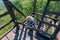 Climbing up by wooden steps in the natural observation tower