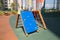 Climbing wall for children on a blue Playground on a clear Sunny day against the background of residential buildings, sports and e