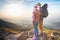 Climbing young couple at top of summit with aerial view