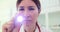 Clinic staff member directs beam of light onto patient