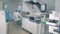 Clinical laboratory with analyzing equipment and several workers in it