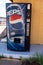 Clinton, Oklahoma - May 6, 2021: Old abandoned Pepsi soda machine sits outside of the abandoned Glancy Motel