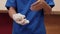 Clip of health worker wearing disposable surgical glove