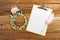 Clipboard attach planning paper with pen beside rose headband