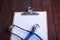 Clipboard with blue stethoscope on white background. Health diagnostic concept