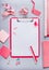 Clipboard with empty copy space blank for list or for input the text, flowers and other supplies, Top view, flat lay. Modern femi