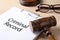 Clipboard with words CRIMINAL RECORD and gavel on table, closeup