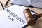 Clipboard with words IMMIGRATION LAW and gavel on table, closeup