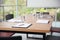 Clipboards and glasses of water on wooden table in modern office