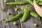 Cloce-up view of Hearthy fresh green peas and pods in wooden bowl