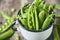 Cloce-up view of Hearthy fresh green peas and pods in wooden bowl