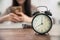 Clock with blur girl teen playing smartphone while reading book
