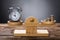 Clock And Coins Balancing On Wooden Weighing Scale
