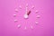 Clock created from white pills and brown tablets on pink background. Right time for using medicines