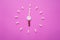 Clock created from white pills and brown tablets on pink background. Right time for using medicines