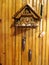 Clock with a cuckoo on a wooden wall