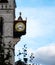 A clock hanging from the side of The Old Bailey