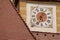 The clock painted outside the bell tower of the church in Selva di Val Gardena into the Dolomites area