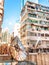 Clock on Rustic Rooftop of Dense High Rise Building in Midday, Hong Kong