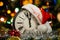 A clock with a Santa hat and Christmas decorations