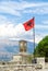 The clock tower and Albanian flag on Gjirokaster Fortress Castle.