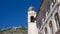 The clock tower of Dubrovnik with the mountain Srd in the background