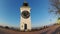 The clock tower on the fortress and the tree without leaves in autumn day in Serbia, city of Petrovaradin - Novi Sad.