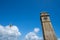 Clock tower of Galle Fort with the Sri Lanka flag blowing in the wind. Negative space composition with extra copy space