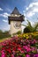 The clock tower (the Uhrturm) and flower garden. Graz, Austria