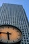 Clock with very tall steel office building