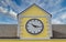 Clock on Yellow Plaster Building