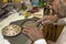 Clockmaker hands repairing antique mantel clock dial