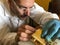 Clockmaker repairs clocks and watches  in his laboratory