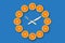 Clocks made of half cut tangerines with arrows made of fork and knife that shows 10 minutes past 10 on a blue background