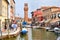 Clocktower, colorful houses and canal on the island of Murano near Venice