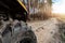 Clode-up detail of ATV awd quadbike motorcycle pov tyre view dirt country forest road beautiful nature morning sunrise