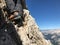 Cloe up view of mountain boots of a climber on a steep climb in the Dolomites