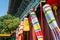 Clolorful Manchu banner and flags standing in front of ancient Chinese buildings, New Yuanming Palace, Zhuhai, China