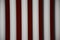 Clos up view of gray color steel bars on dark red blurred background