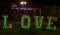 Close. Against the background of a lantern, photo area. Wedding decor. Large white letters, with green lights, with the inscriptio