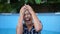 Close beautiful portrait of a teenage girl under a stream of clear water. The girl was doused with water, she laughs and