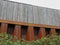 Close boarded wooden motorway fence on top of iron retaining wall